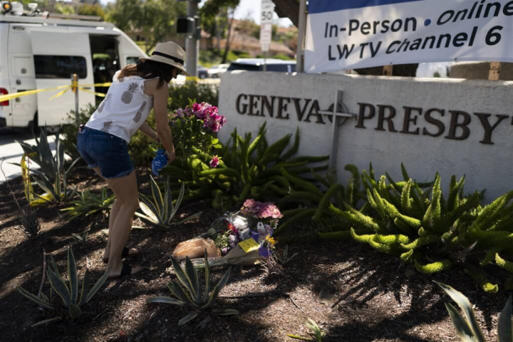 A woman lays flowers at the attacked church in California Monday. Photo: AP