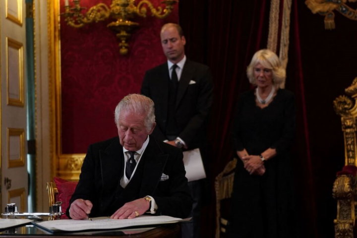 Britain's King Charles (front) signs an oath during the Accession Council at St James's Palace in London, where he is formally proclaimed, with Prince William (back left) and Queen Consort Camilla standing behind him. Photo: Reuters