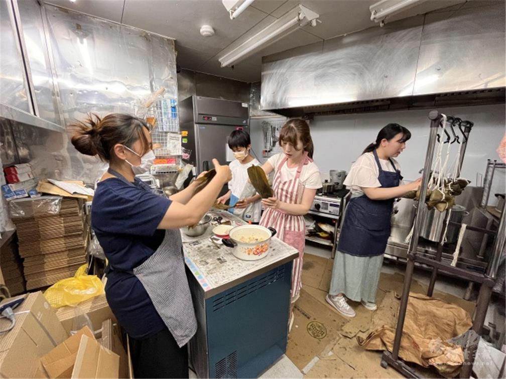 Members work diligently to making zongzi.